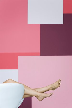 single geometric shape - Woman reclining on armchair, cropped view of bare legs Stock Photo - Premium Royalty-Free, Code: 632-02745290