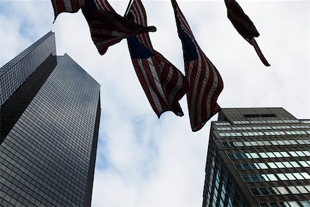 simsearch:632-02885210,k - Skyscrapers, flags waiving in breeze, viewed from below Stock Photo - Premium Royalty-Free, Code: 632-02885201