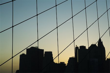 simsearch:632-02885210,k - United States, New York City, silhouette of Manhattan skyline seen through Brooklyn Bridge Stock Photo - Premium Royalty-Free, Code: 632-02885214