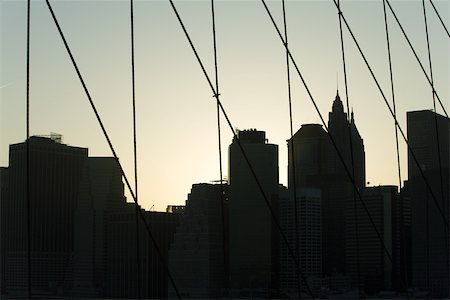 simsearch:632-02885210,k - United States, New York City, silhouette of Manhattan skyline seen through Brooklyn Bridge Stock Photo - Premium Royalty-Free, Code: 632-02885229