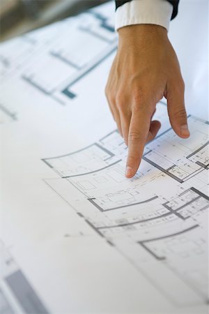 finger pointing and touching not illustration and one person - Hand pointing at area on blueprint, close-up Stock Photo - Premium Royalty-Free, Code: 632-02885346