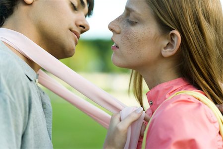 Young couple leaning in to kiss, eyes closed, side view Stock Photo - Premium Royalty-Free, Code: 632-02885427