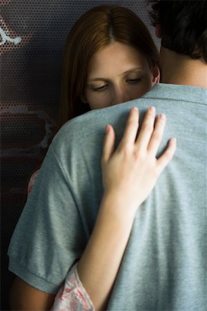 sad lover image backside - Young couple embracing stiffly, woman looking down Stock Photo - Premium Royalty-Free, Code: 632-02885440