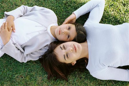 Mother and daughter reclining together in grass, viewed from directly above Stock Photo - Premium Royalty-Free, Code: 632-03026994