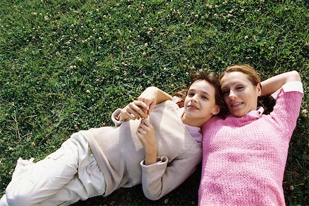 simsearch:632-02416107,k - Mother and daughter lying together on grass, smiling at camera Stock Photo - Premium Royalty-Free, Code: 632-03026990