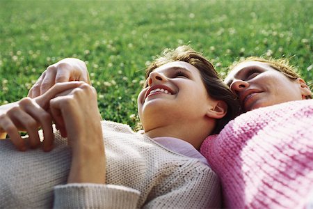 simsearch:632-02416107,k - Mother and daughter reclining together on grass, girl resting head on mother's shoulder Stock Photo - Premium Royalty-Free, Code: 632-03027007