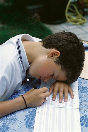 photo of boy sitting with his head down - Young boy correcting music homework Stock Photo - Premium Royalty-Free, Code: 632-03027079