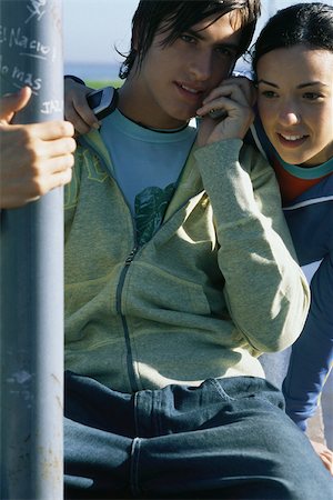 Young friends listening to cell phone together Stock Photo - Premium Royalty-Free, Code: 632-03027136