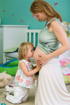 daughter kissing mother - Little girl kissing mother's pregnant belly Stock Photo - Premium Royalty-Free, Code: 632-03027237