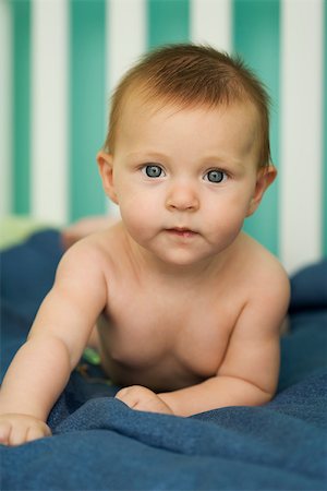 Baby lying on stomach, looking at camera, portrait Stock Photo - Premium Royalty-Free, Code: 632-03027231
