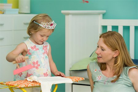 simsearch:693-06016146,k - Little girl playing in bedroom with mother, pretending to iron Stock Photo - Premium Royalty-Free, Code: 632-03027255