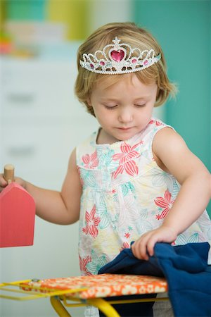 Little girl pretending to iron Stock Photo - Premium Royalty-Free, Code: 632-03027267