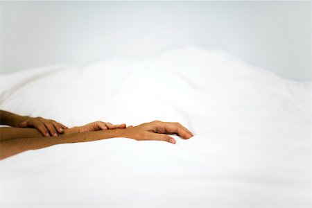 Hands touching on comforter Stock Photo - Premium Royalty-Free, Code: 632-03083367