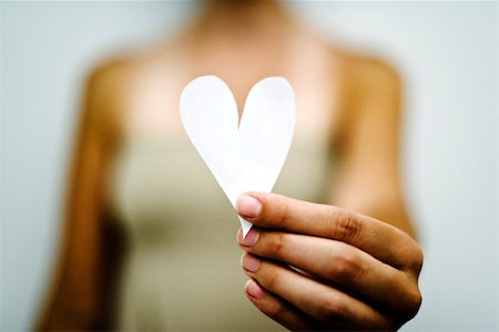 Woman's hand holding out paper heart Stock Photo - Premium Royalty-Free, Code: 632-03083373