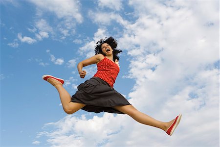 simsearch:628-01586462,k - Young woman jumping in midair, low angle view Stock Photo - Premium Royalty-Free, Code: 632-03083395
