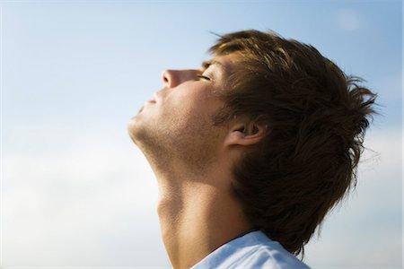 Jeune homme à l'extérieur avec la tête en arrière, les yeux fermés Photographie de stock - Premium Libres de Droits, Code: 632-03083402