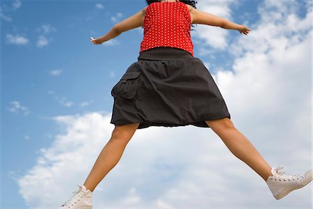 simsearch:633-01837186,k - Young woman jumping in midair, cropped Stock Photo - Premium Royalty-Free, Code: 632-03083424