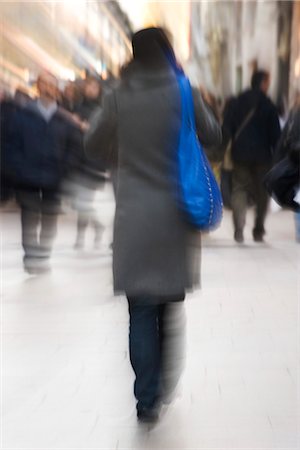 Pedestrians walking on sidewalk, rear view, blurred Stock Photo - Premium Royalty-Free, Code: 632-03083490