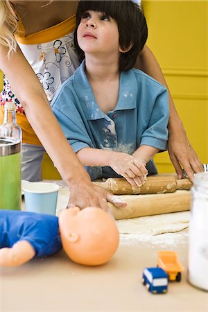 parent child messy cooking - Boy rolling out dough with mother, cropped Stock Photo - Premium Royalty-Free, Code: 632-03083566