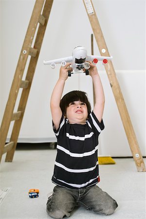 Little boy playing with toy airplane Stock Photo - Premium Royalty-Free, Code: 632-03083561