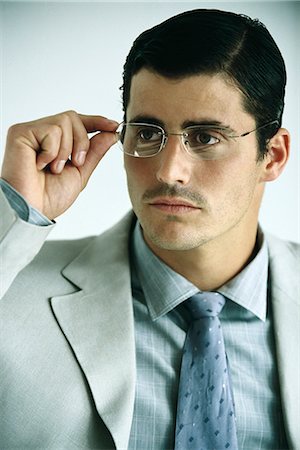 simsearch:632-03500989,k - Businessman adjusting glasses, portrait Stock Photo - Premium Royalty-Free, Code: 632-03083761