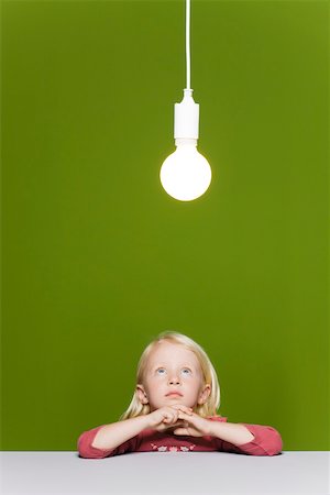 simsearch:632-03193659,k - Little girl contemplating illuminated light bulb suspended overhead Foto de stock - Royalty Free Premium, Número: 632-03193341