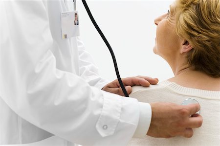 simsearch:632-03516747,k - Doctor listening to patient's back with stethoscope, cropped Stock Photo - Premium Royalty-Free, Code: 632-03193474