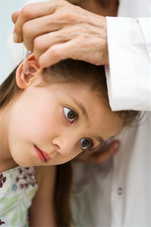 ear (sensory organ) - Doctor putting drops in little girl's ear, cropped Stock Photo - Premium Royalty-Free, Code: 632-03193478