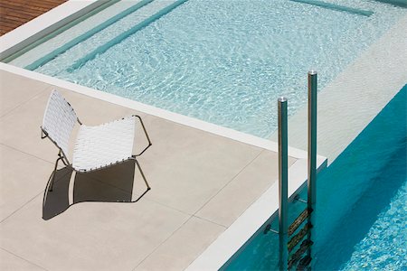 simsearch:632-03779504,k - Chair at edge of pool near ladder Stock Photo - Premium Royalty-Free, Code: 632-03193608