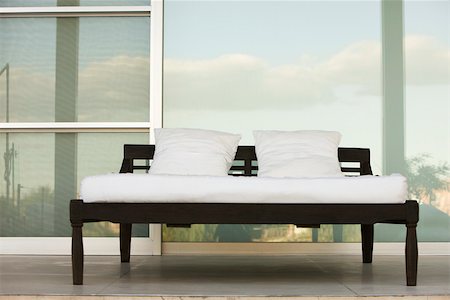 Bed on outdoor patio at resort Stock Photo - Premium Royalty-Free, Code: 632-03193617