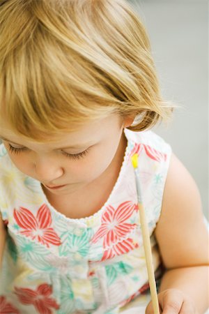 Toddler girl holding paintbrush, looking down Stock Photo - Premium Royalty-Free, Code: 632-03193695