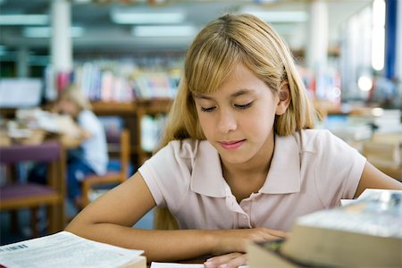 Preteen girl studying in library Stock Photo - Premium Royalty-Free, Code: 632-03403131