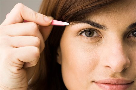 plucking - Young woman tweezing eyebrows Stock Photo - Premium Royalty-Free, Code: 632-03403333