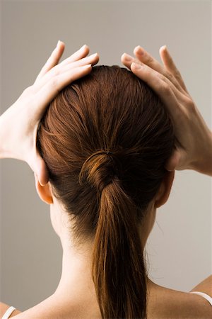 ponytail back view - Woman styling hair, rear view Stock Photo - Premium Royalty-Free, Code: 632-03403356