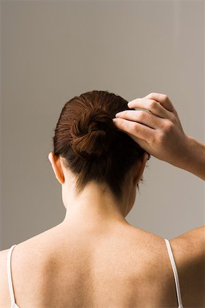 fixing hair - Woman styling hair, rear view Stock Photo - Premium Royalty-Free, Code: 632-03403360