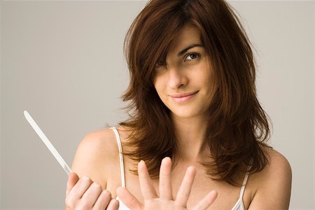 simsearch:695-03380090,k - Young woman filing nails Stock Photo - Premium Royalty-Free, Code: 632-03403376