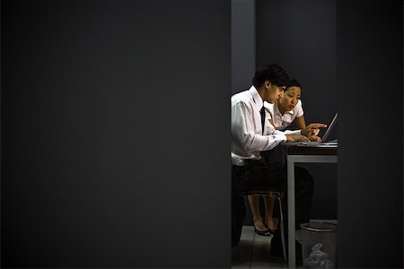 Business associates together in office working late Stock Photo - Premium Royalty-Free, Code: 632-03403442