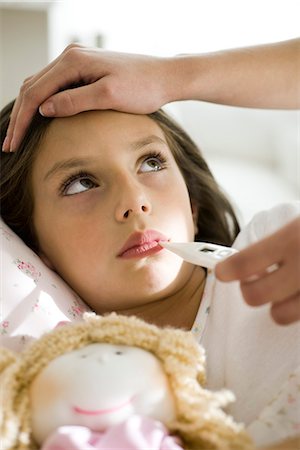 parents checking the children - Mother checking daughter's temperature, caressing forehead, cropped Stock Photo - Premium Royalty-Free, Code: 632-03424325