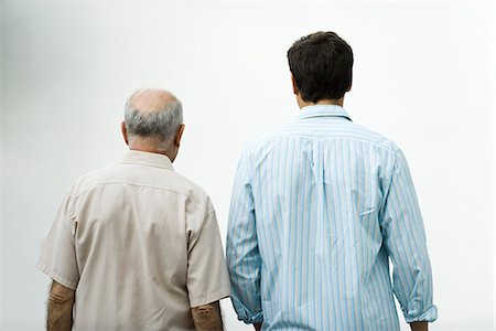 dad silhouette - Senior man walking with adult son, rear view Stock Photo - Premium Royalty-Free, Code: 632-03424371