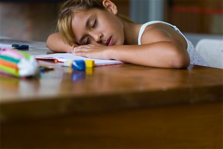 pencil case - Girl resting head on arms asleep at desk Stock Photo - Premium Royalty-Free, Code: 632-03424538