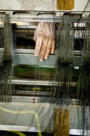 Fabric coating plant, weaving department, mechanist preparing weaver's reed on loom Stock Photo - Premium Royalty-Free, Code: 632-03500536