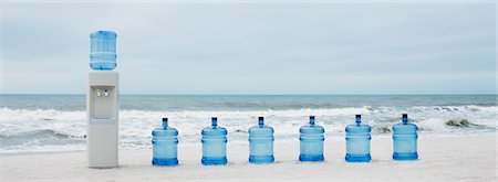 ecology water - Water cooler and water jugs lined up on beach Stock Photo - Premium Royalty-Free, Code: 632-03500611