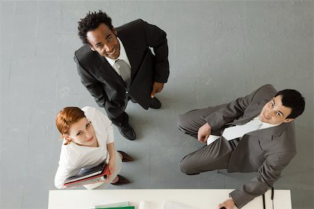 desk directly above - Business colleagues in office, all smiling up at camera Stock Photo - Premium Royalty-Free, Code: 632-03500805