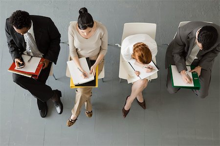 Professionals taking notes during meeting Stock Photo - Premium Royalty-Free, Code: 632-03500807