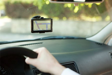 Driver using GPS unit for navigation assistance Stock Photo - Premium Royalty-Free, Code: 632-03500884