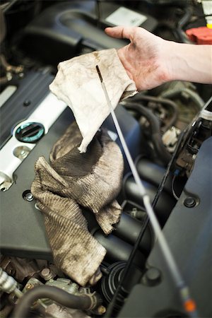 dirty mechanics - Checking car engine oil Stock Photo - Premium Royalty-Free, Code: 632-03500926