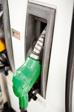 Nozzle in place on gas pump Stock Photo - Premium Royalty-Free, Code: 632-03500944