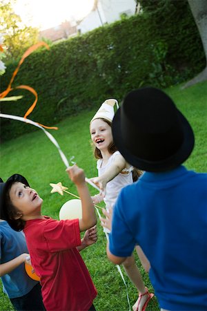 simsearch:632-03500989,k - Children pulling streamers attached to pull string pinata Stock Photo - Premium Royalty-Free, Code: 632-03501013