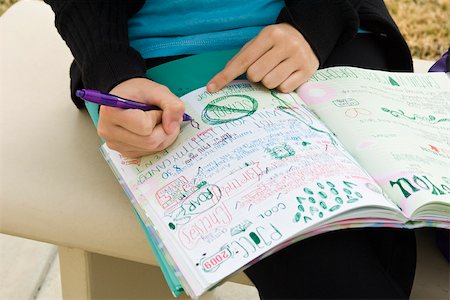 Student writing in notebook illustrated with doodles Foto de stock - Sin royalties Premium, Código: 632-03501043
