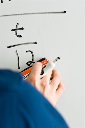 Writing equation on whiteboard Foto de stock - Sin royalties Premium, Código: 632-03501112